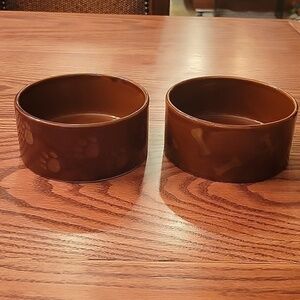 Two dark brown ceramic stoneware dog bowls.  5" in diameter 2 1/4' high